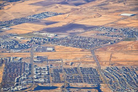 Daybreak Lake and Community and Oquirrh Mountains aerial, Copper Mine, Wasatch Front Rocky Mountains from airplane during fall. South Jordan and Herriman, Utah. United States of America. USA.の写真素材