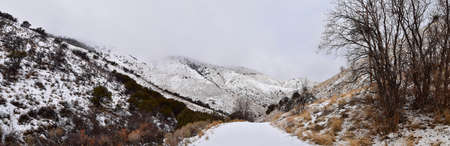 Snowy Hiking Trail views towards Lake Mountains Peak via Israel Canyon road towards Radio Towers in winter, Utah Lake, Wasatch Front Rocky Mountains, Provo, United States.の写真素材