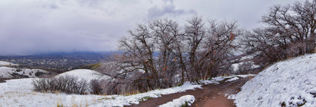 Little Black Mountain Peak hiking trail views by Salt Lake City, in winter snowscape via Bonneville Shoreline Trail, Wasatch Front Rocky Mountains, Utah. United States.の写真素材