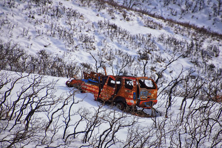 Truck old and rusty graffiti abandoned in the snow covered Mountains Lone Peak Wilderness Wasatch Rocky Mountains, Utah. United States.の写真素材