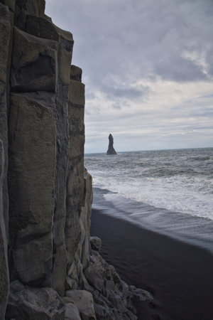 Reynisfjara black-sand beach found on the Ocean South Coast of Iceland, basalt columns and the dramatic Reynisdrangar sea stacks. Iceland, Europe.の写真素材