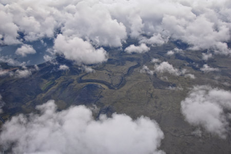 Iceland from airplane through clouds. Aerial scenic view of Iceland landscape. Travel vacation concept. Europe.の写真素材