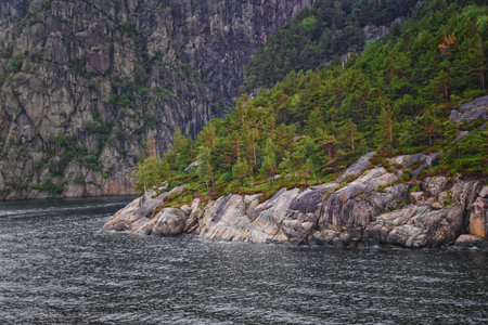 Norway Coast Fjord view from boat on ocean. Mountains, forests, waterfalls and small towns. Scandinavia, Norwayの写真素材