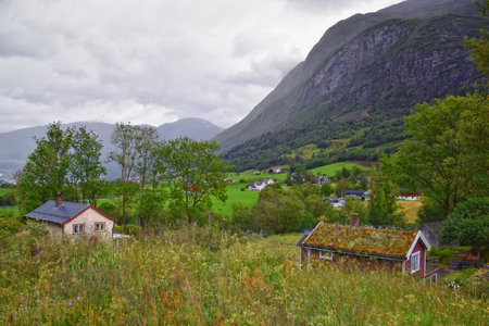 View to Sognefjord Olden in Norway. Small town cruise port Olden Norwegian fjords, Rorbu houses. By Briksdal Glacier. Scandinavia, Europe.の写真素材