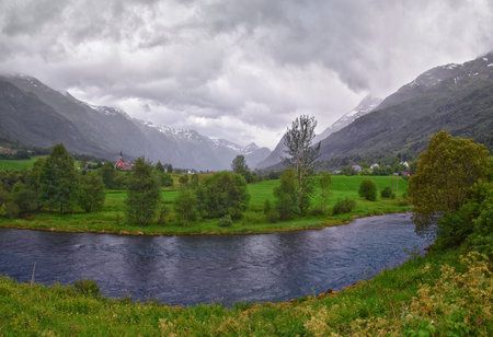 View to Sognefjord Olden in Norway. Small town cruise port Olden Norwegian fjords, Rorbu houses. By Briksdal Glacier. Scandinavia, Europe.の写真素材