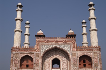 Ornate entrance to Akbar's Tomb. Islamic style architecture. Red sandstone building inlaid with white marble with marble minarets at each corner. Sikandra, Agra, Indiaの写真素材