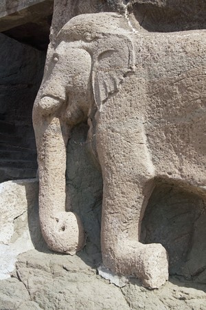 Elephant statue in the cliff marking the entrance to the ancient Buddhist cave temples at Ajanta, near Aurangabad, India. 2nd Century BC to 6th Century ADの写真素材