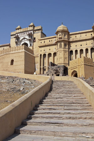 Steps leading up to the imposing front entrance (Suraj Pol) to Amber Fort. Large honey coloured...