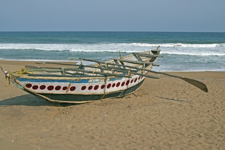 Wooden fishing boat on a sandy beach.の写真素材
