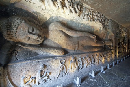 Statue of a reclining Buddha carved on the wall of the ancient Buddhist rock temple (Mahayan Chaitya-Griha Cave Temple) Ajanta Caves near Aurangabad India. 5th-6th Century AD.の写真素材