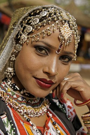 Haryana, India - February 12, 2009: Portrait of a beautiful Indian Kalbelia dancer in ornate headdress and traditional jewellery at the Sarujkund Craft Fair in Haryana near Delhi, India.のeditorial素材