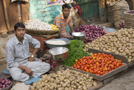 Delhi, India - January 5, 2009: Men selling vegetables from a pavement stall in Delhi, India.のeditorial素材