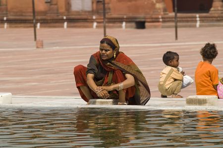 Delhi, India - September 19, 2006: Indian women washing in a water tank in the courtyard of the Jama Masjid (Friday Mosque) in Old Delhi, Indiaのeditorial素材