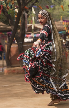 Female kalbelia dancer in traditional tribal dress performing at the annual Sarujkund Fair near Delhi, Indiaの写真素材