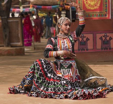 Female kalbelia dancer in traditional tribal dress performing at the annual Sarujkund Fair near Delhi, Indiaの写真素材