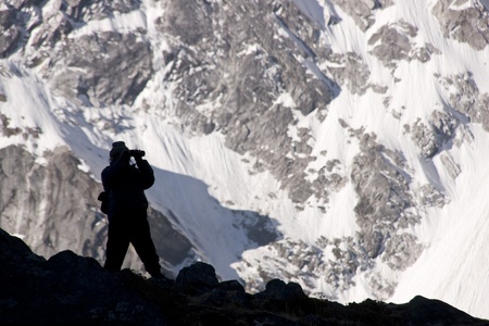 Silhouette of a man on the lookout for wildlife high in the Himalaya Mountains of Nepalの写真素材