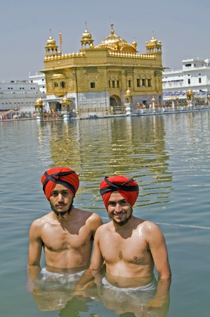 Amritsar, India - April 21, 2007: Sikh men bathing in the holy pool at the Golden Temple, Amritsarのeditorial素材