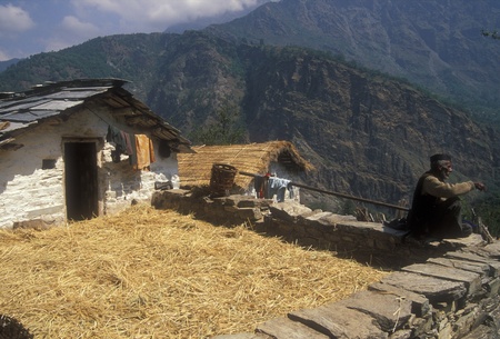 Himalaya Mountains, India - May 15, 2007: Man sitting on the wall of his traditional cottage high in the mountains of the Indian Himalaya.のeditorial素材