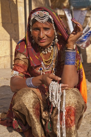 Jaisalmer, Rajasthan, India - February 3, 2007:  Indian lady in traditional outfit selling silver necklaces at Jaisalmer Fort during the annual Desert Festival.のeditorial素材