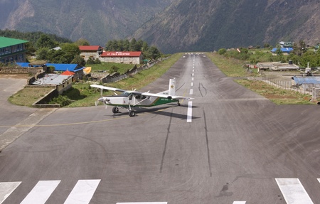 Lukla, Nepal - May 9, 2010: Small aircraft landing at the small airfield at Lukla in the Nepalese Himalayas.のeditorial素材