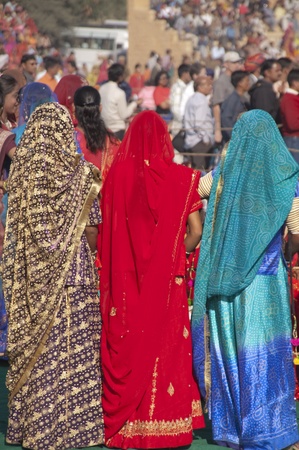 Jaisalmer, Rajasthan, India - January 31, 2007: Women in coloful fabrics watch proceedings at the annual Desert Festival in Jaisalmer, Rajasthan, Indiaのeditorial素材