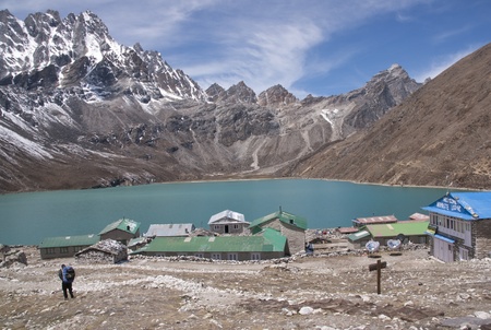 Himalaya Mountains, Nepal - May 20, 2010: Buildings in the village of Gokyo next to a still lake and surrounded by mountains 4800 meters up in the Himalaya Mountains of Nepal.のeditorial素材