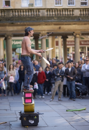 Bath, England - March 19, 2011: Street artist juggling with knives in Abbey Churchyard, Bath, Somerset, Englandのeditorial素材