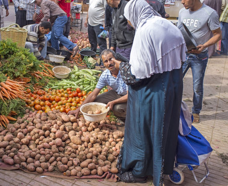 Taroudant, Morocco - October 25, 2012: Woman buying fresh vegetables from the market in the ancient town of Taroudant in Morocco.のeditorial素材