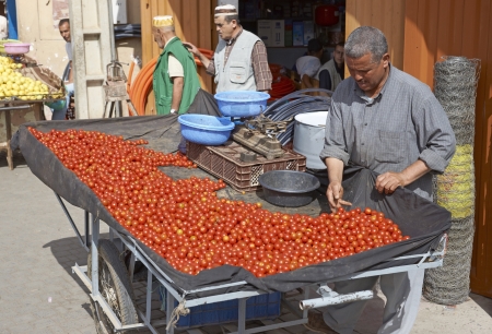 Taroudant, Morocco - October 24, 2012: Man selling tomatoes from a hand cart in the ancient town of Taroudant in Morocco.のeditorial素材