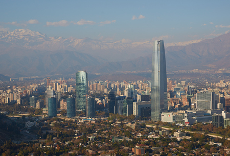 Modern office and apartment blocks of Santiago in Chile against the backdrop of the snow capped mountains of the Andes のeditorial素材