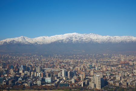 Snow covered mountains surrounding the modern high rise buildings of Santiago, the capital of Chile  View from Cerro San Cristobal のeditorial素材