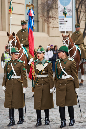 Santiago, Chile - August 4, 2014  Female members of the Carabineros marching with a ceremonial flag as part of the changing of the guard ceremony at La Moneda in Santiago, Chile         のeditorial素材