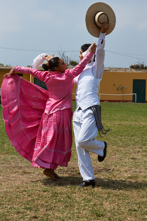 Trujillo, Peru - September 1, 2014: Lady in pink dress dancing a traditional folk dance in Trujillo, Peruのeditorial素材