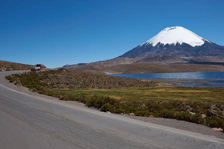 Snow capped Parinacota Volcano, 6,324m high, towering over Lake Chungara in the Altiplano of northern Chile.の写真素材