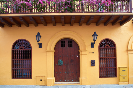 Yellow facade of a house in the historic UNESCO World Heritage Site of Cartagena de Indias in Colombiaのeditorial素材