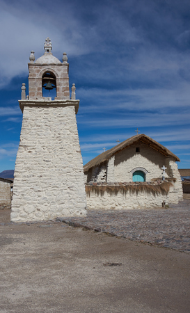 Historic church in the small village of Guallatire on the Altiplano in the Arica y Parinacota Region of Chile. The village sits at the base of the active Guallatire Volcano.の写真素材