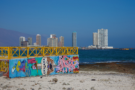 IQUIQUE, CHILE - JULY 7, 2015: Colourful murals decorating a wall on the beach at Iquique in northern Chile.のeditorial素材