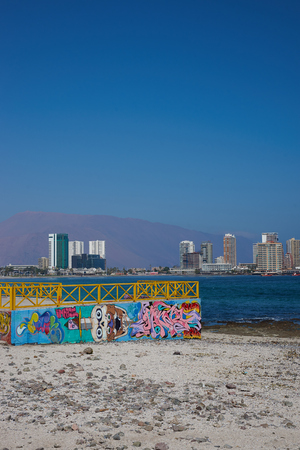 IQUIQUE, CHILE - JULY 7, 2015: Colourful murals decorating a wall on the beach at Iquique in northern Chile.のeditorial素材