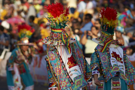 ARICA, CHILE - JANUARY 22, 2016: Tinku dancing group in colourful costumes performing a traditional ritual dance as part of the Carnaval Andino con la Fuerza del Sol in Arica, Chile.のeditorial素材