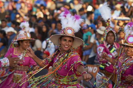 ARICA, CHILE - JANUARY 23, 2016: Tinku dancing group in colourful costumes performing a traditional ritual dance as part of the Carnaval Andino con la Fuerza del Sol in Arica, Chile.のeditorial素材
