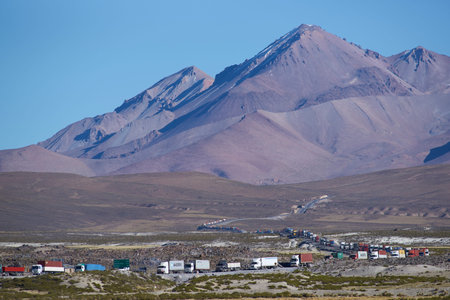 LAUCA NATIONAL PARK, CHILE - MAY 11, 2016: Long line of trucks waiting on the altiplano of northern Chile to cross into Bolivia.のeditorial素材