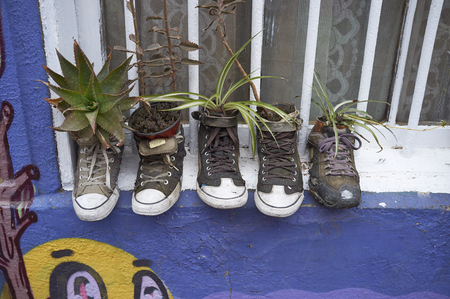 VALPARAISO, CHILE - NOVEMBER 29, 2016: Old shoes on a windowsill being used for plants in the historic coastal city of Valparaiso in Chile.のeditorial素材