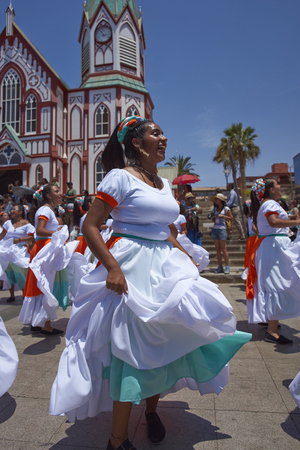 ARICA, CHILE - FEBRUARY 10, 2017: Female members of an ethnic dance group comprising of people of African descent, dancing as part of the parade at the annual Carnaval Andino con la Fuerza del Sol.のeditorial素材