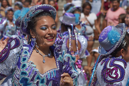 ARICA, CHILE - FEBRUARY 10, 2017: Female members of a Caporales dance group in ornate costumes performing at the annual Carnaval Andino con la Fuerza del Sol in Arica, Chile.のeditorial素材