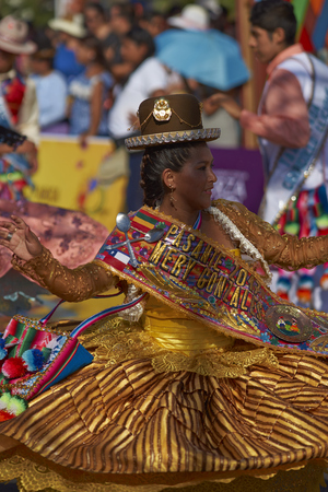 ARICA, CHILE - FEBRUARY 10, 2017: Female member of a Pueblo dance group in ornate costume performing at the annual Carnaval Andino con la Fuerza del Sol in Arica, Chile.のeditorial素材