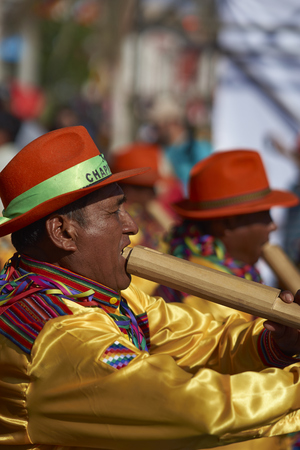 ARICA, CHILE - FEBRUARY 10, 2017: Male members of the band of a Pueblo dance group in ornate costume performing at the annual Carnaval Andino con la Fuerza del Sol in Arica, Chile.のeditorial素材