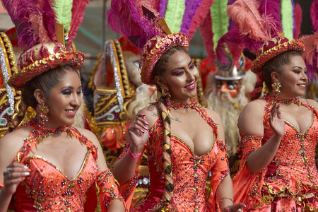 ORURO, BOLIVIA - FEBRUARY 25, 2017: Female Morenada dancers in colourful costumes parading through the mining city of Oruro on the Altiplano of Bolivia during the annual Oruro Carnival.のeditorial素材