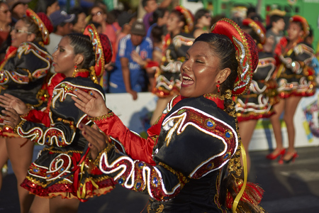 ARICA, CHILE - FEBRUARY 10, 2017: Female members of a Caporales dance group in ornate costumes performing at the annual Carnaval Andino con la Fuerza del Sol in Arica, Chile.のeditorial素材