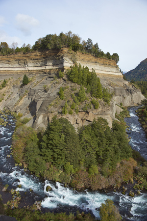 River Truful-Truful running through a deep gorge with colourful eroded cliffs in Conguillio National Park in the Araucania region of Chileの写真素材