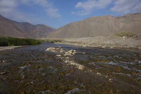 River Loa emerging from the Atacama Desert before flowing into the Pacific Ocean in the Tarapaca Region of northern Chile.の写真素材